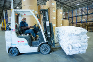 Person Handling a Forklift with Recycle Materials