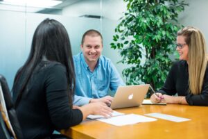 3 people having a conversation in a conference room